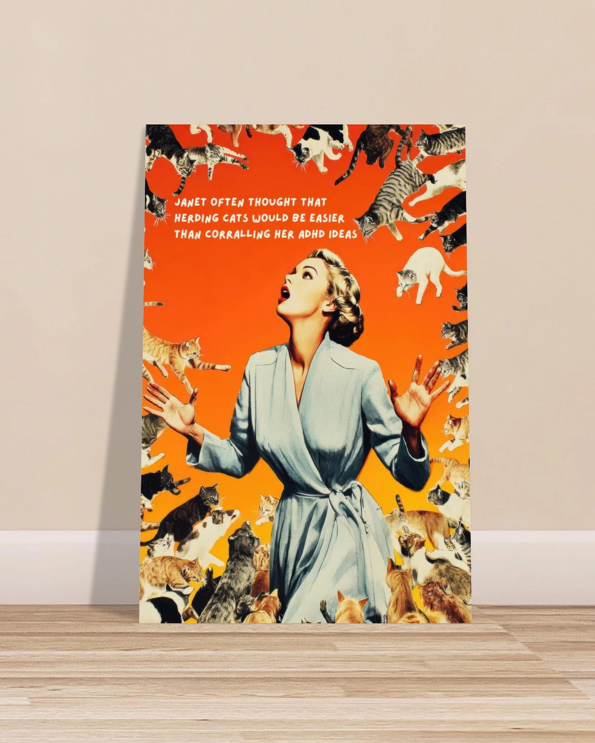 Janet Herding Cats Vignette poster: a woman in a blue robe surrounded by leaping cats on orange, leaning against a beige wall