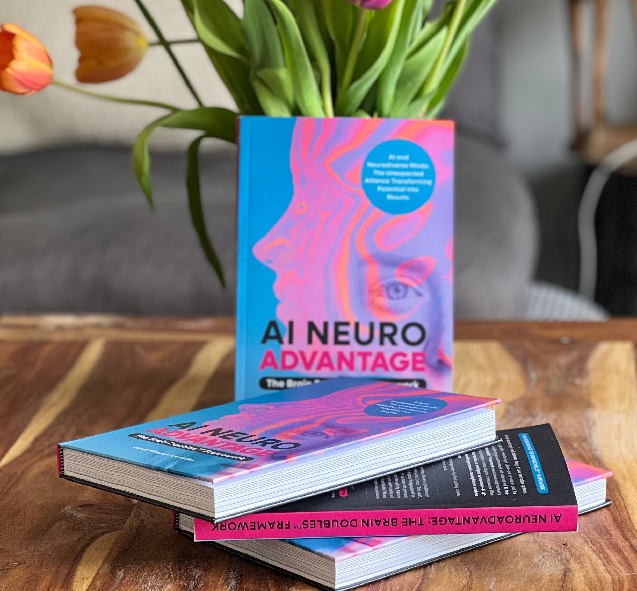 Stack of books titled 'AI Neuro Advantage' with a vase of tulips on a wooden table.