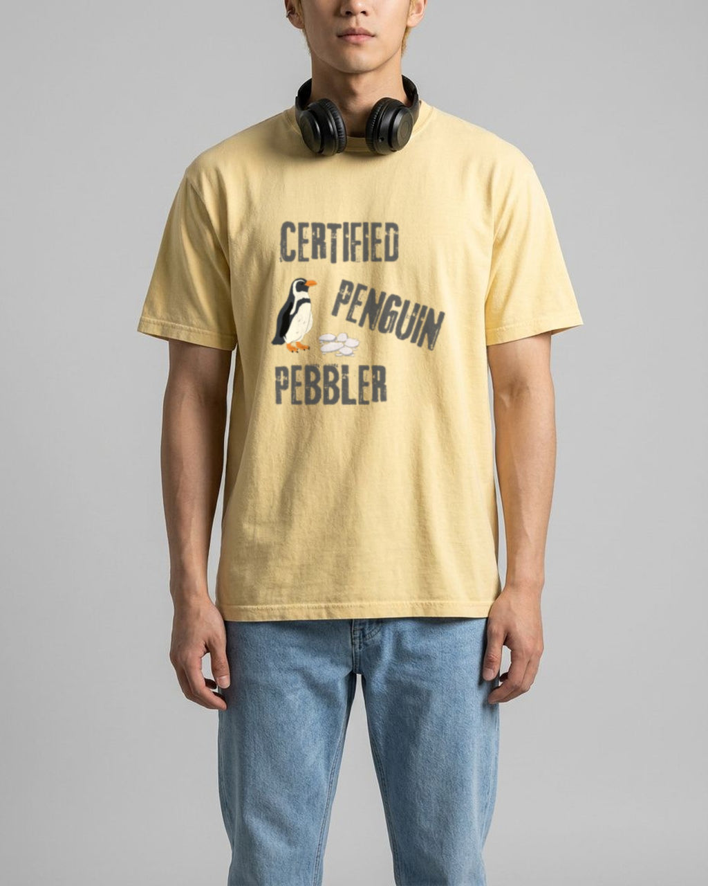 Certified Penguin Pebbler tee in Butter, worn, front view showing the print