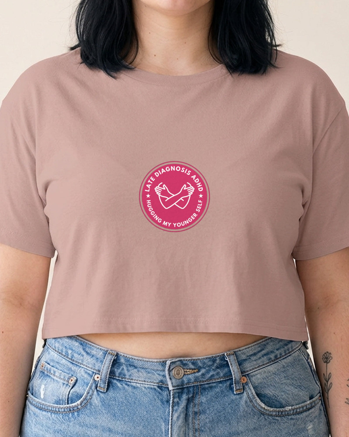 Hugging ... ADHD embroidered crop top in Hazy Pink, worn, close-up of the embroidery