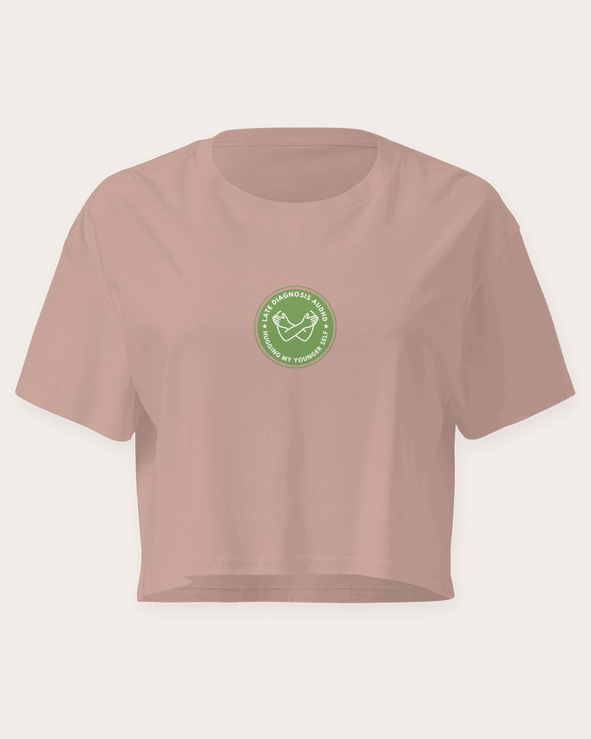 Hugging ... AuDHD embroidered crop top in Hazy Pink, flat front view