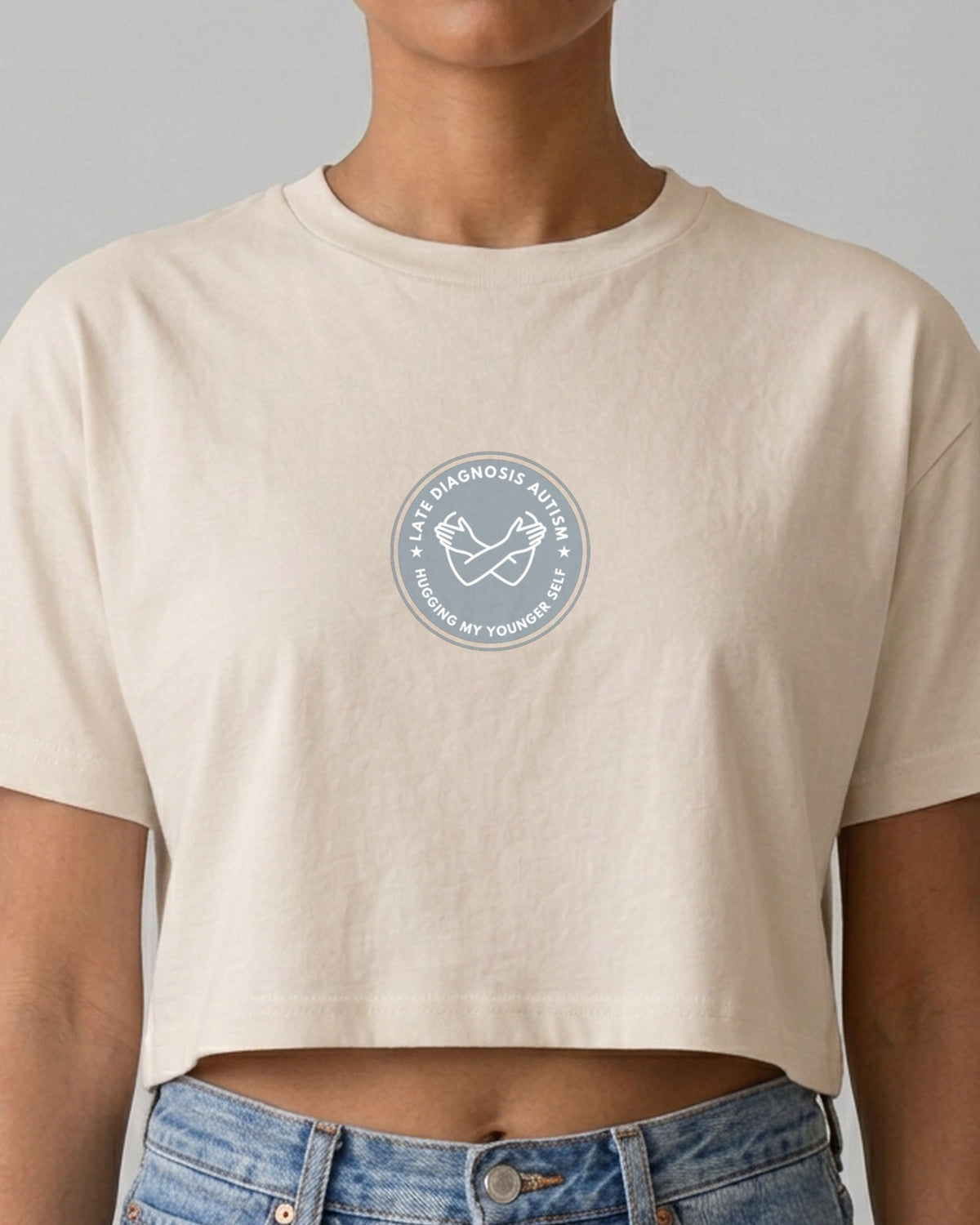 Hugging ... Autism embroidered crop top in Bone, worn, close-up of the embroidery