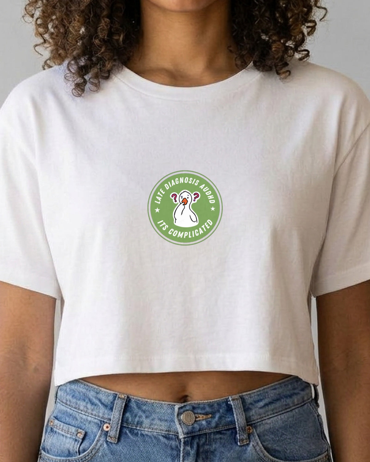 It's Complicated (AuDHD) embroidered crop top in White, worn, close-up of the embroidery