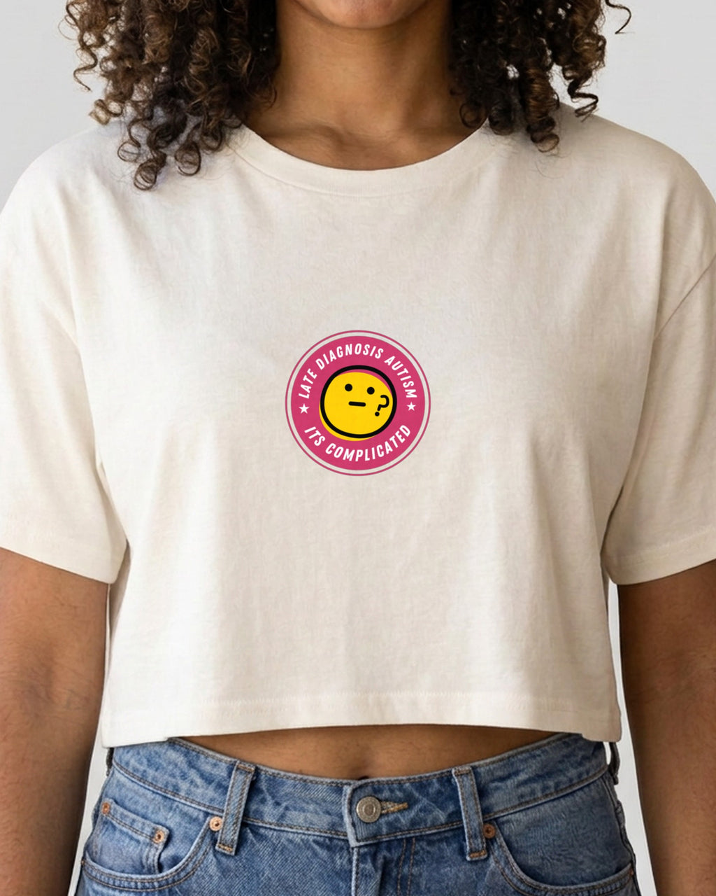 It's Complicated Autism embroidered crop top in Ecru, worn, close-up of the embroidery