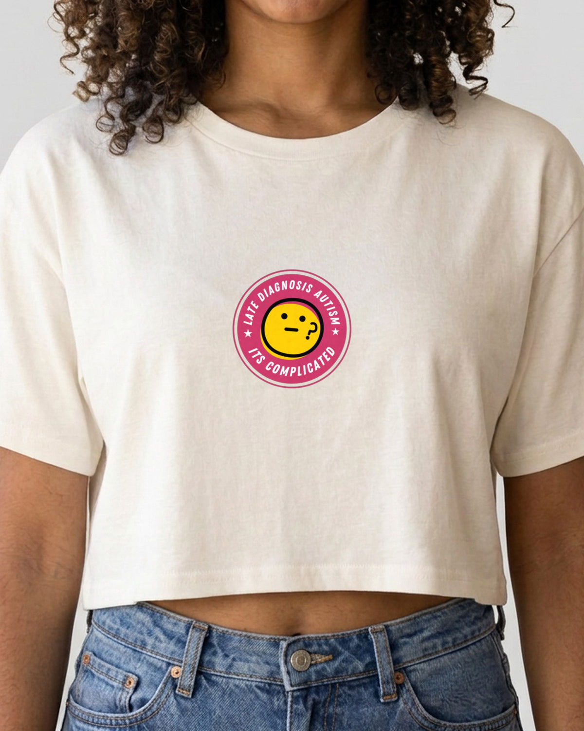 It's Complicated Autism embroidered crop top in Ecru, worn, close-up of the embroidery