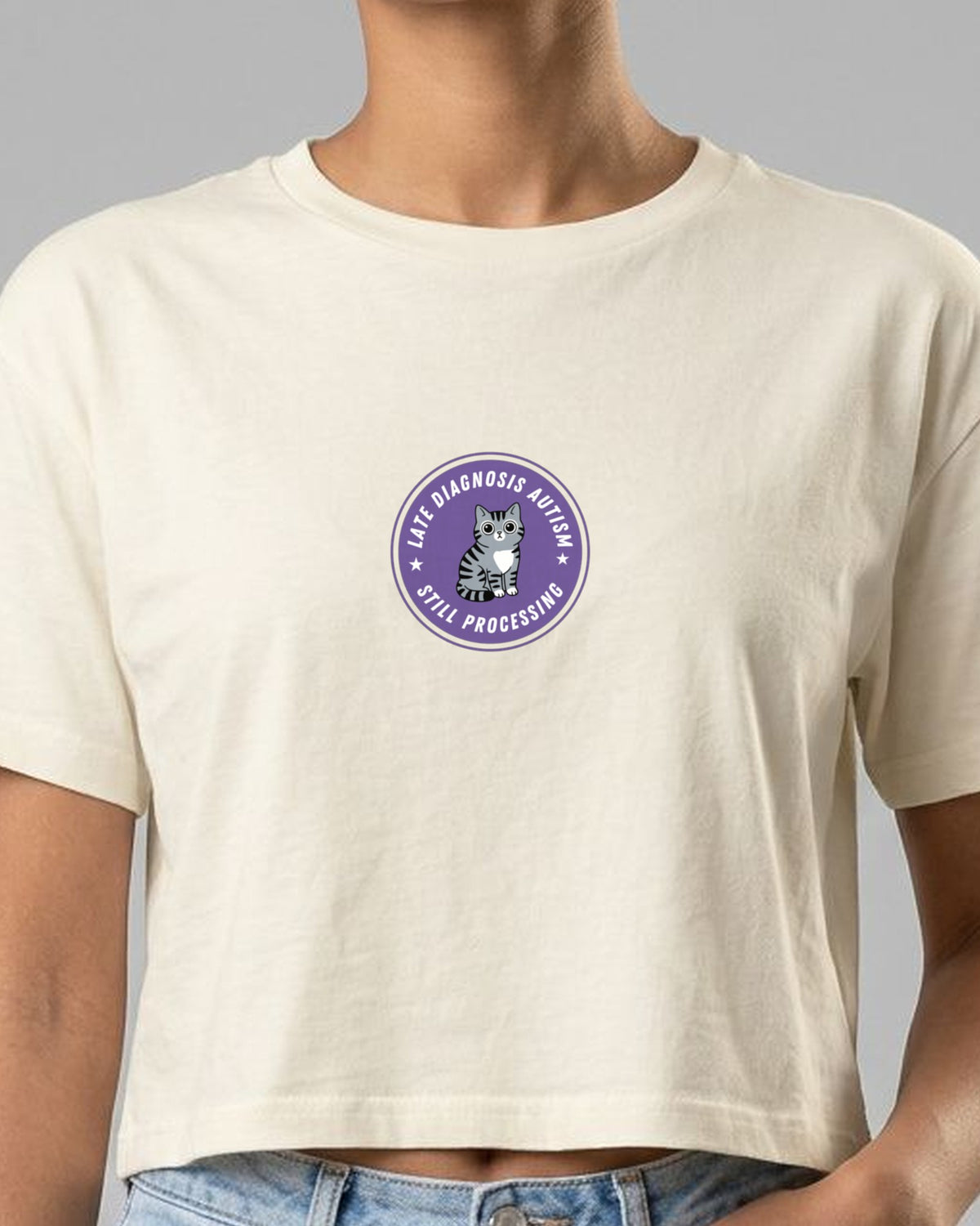 Still Processing (Autism) embroidered crop top in Natural, worn, close-up of the embroidery
