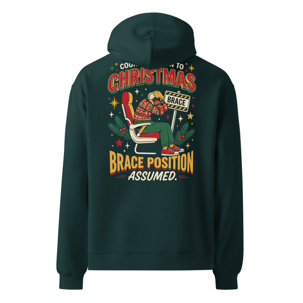 Brace for Christmas! oversized hoodie in Pine Green, back view of the full-size printed design