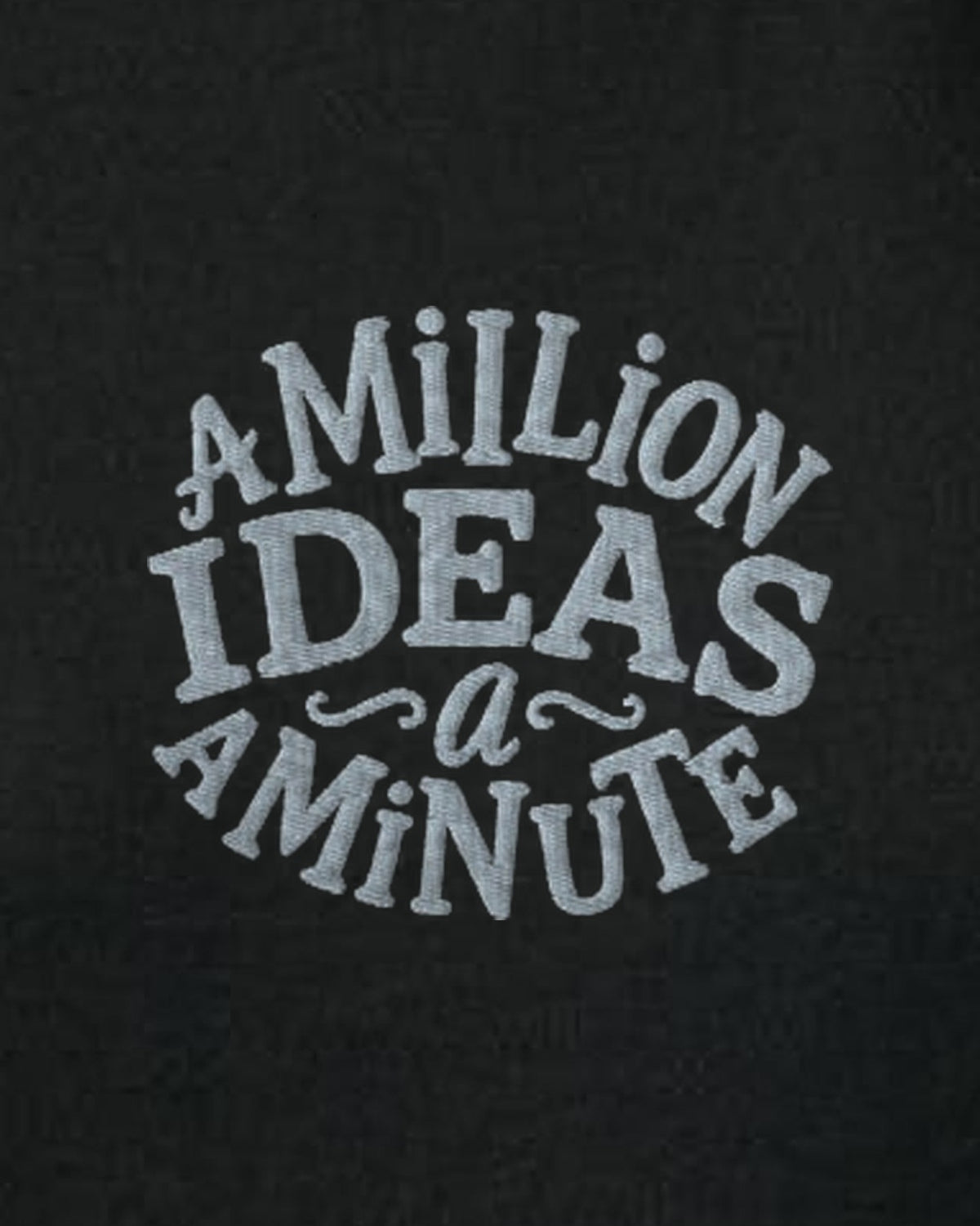 A Million Ideas embroidered women's organic sweatshirt in Black, close-up of the embroidered slogan