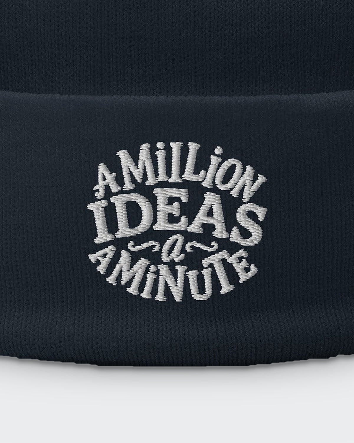 A Million Ideas (beanie) embroidered dad hat in Navy, close-up of the embroidery