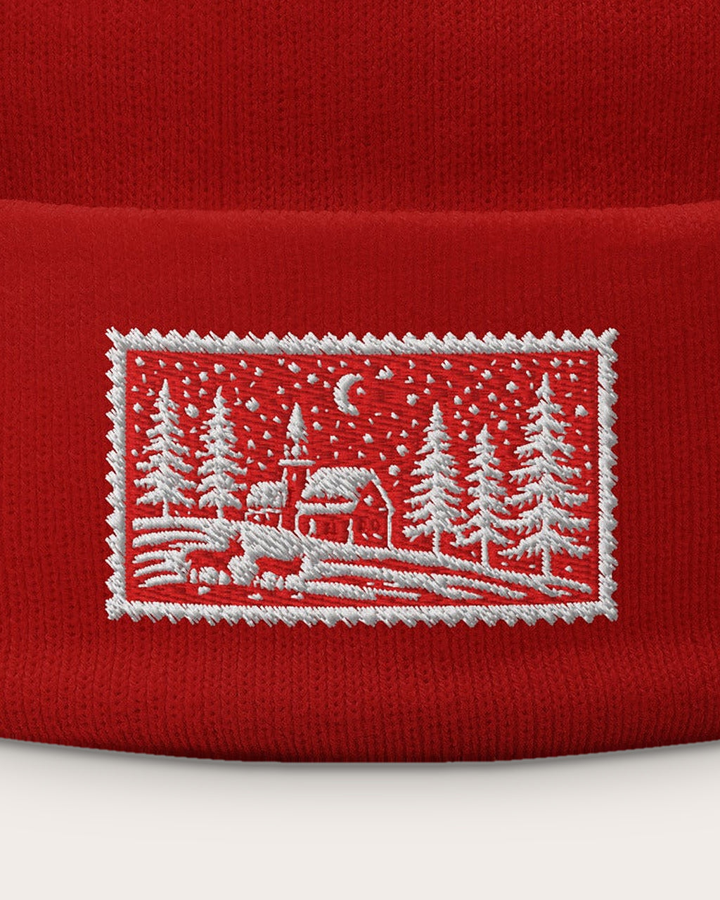 Christmas Scene Stamp embroidered beanie in Red, close-up of the embroidered stamp
