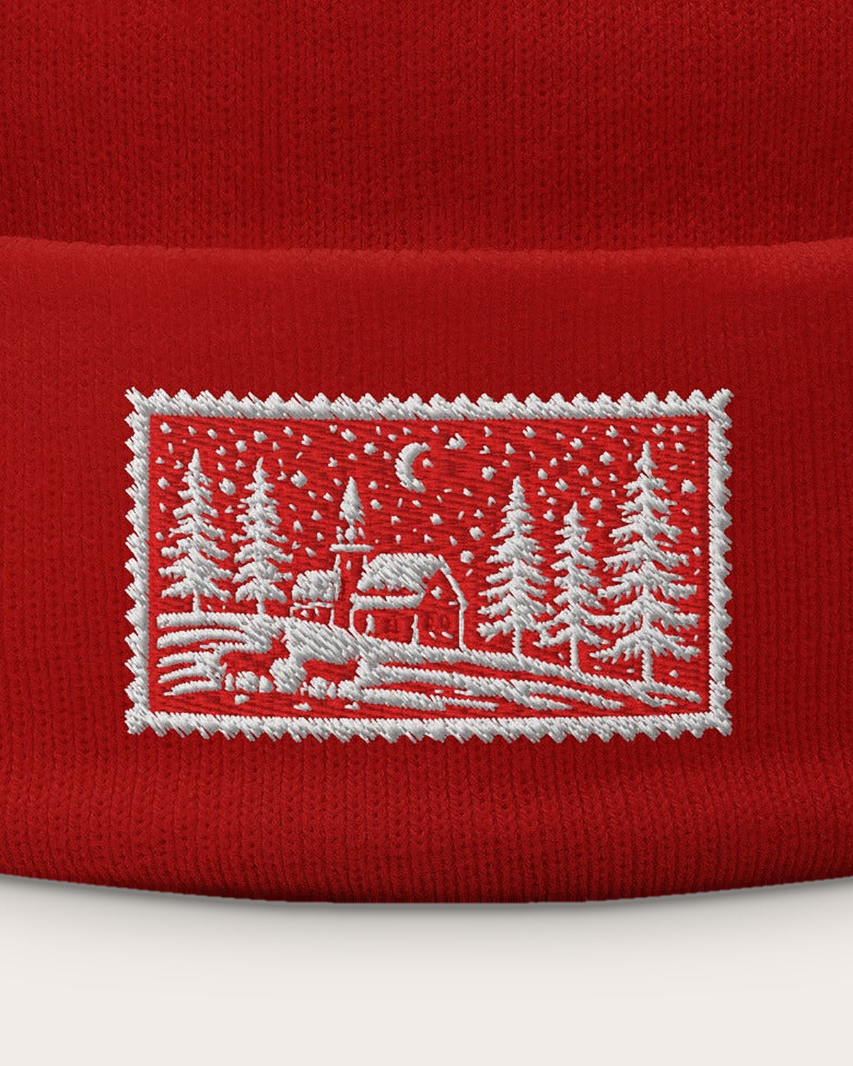 Christmas Scene Stamp embroidered beanie in Red, close-up of the embroidered stamp
