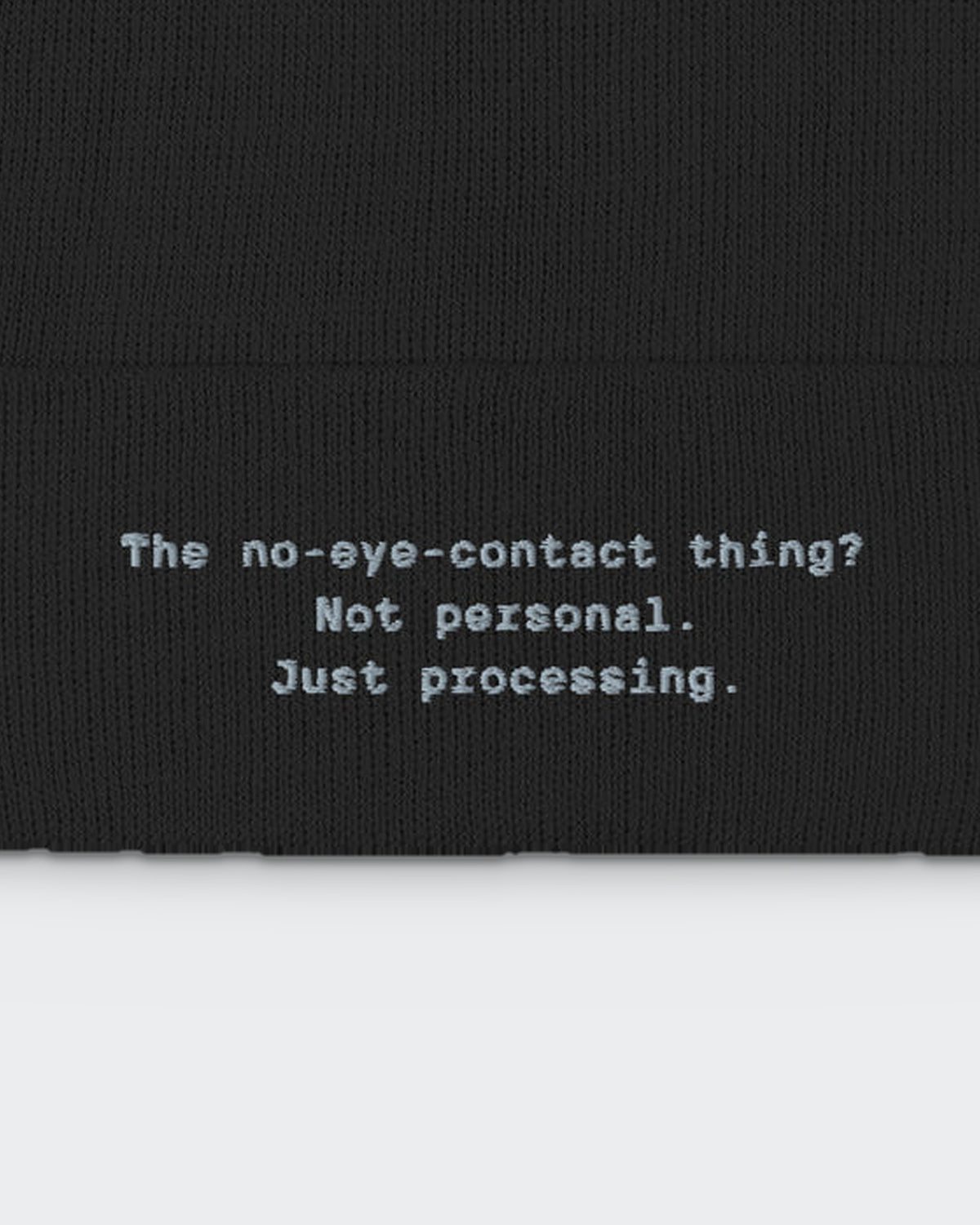 The Eye Contact Thing (beanie) embroidered dad hat in Black, close-up of the embroidery