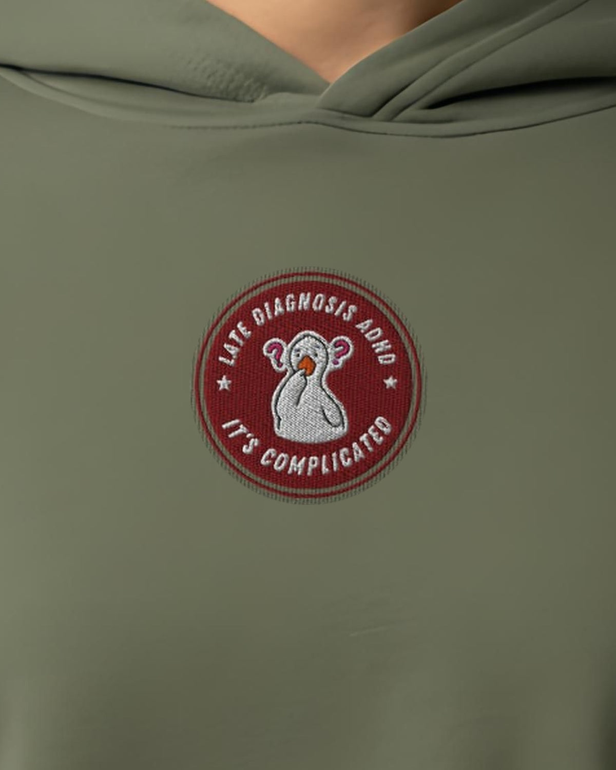It's Complicated (ADHD) embroidered crop hoodie in Military Green, worn, close-up of the chest design