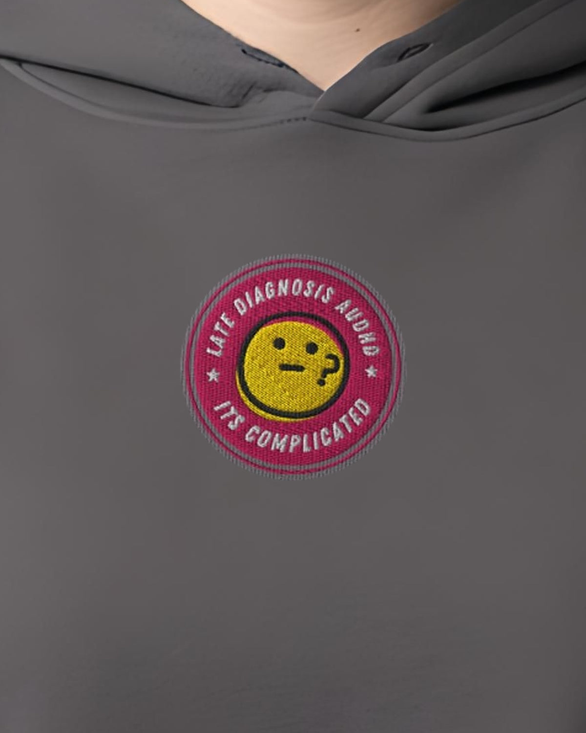 It's Complicated (AuDHD) embroidered crop hoodie in Storm, worn, close-up of the chest design