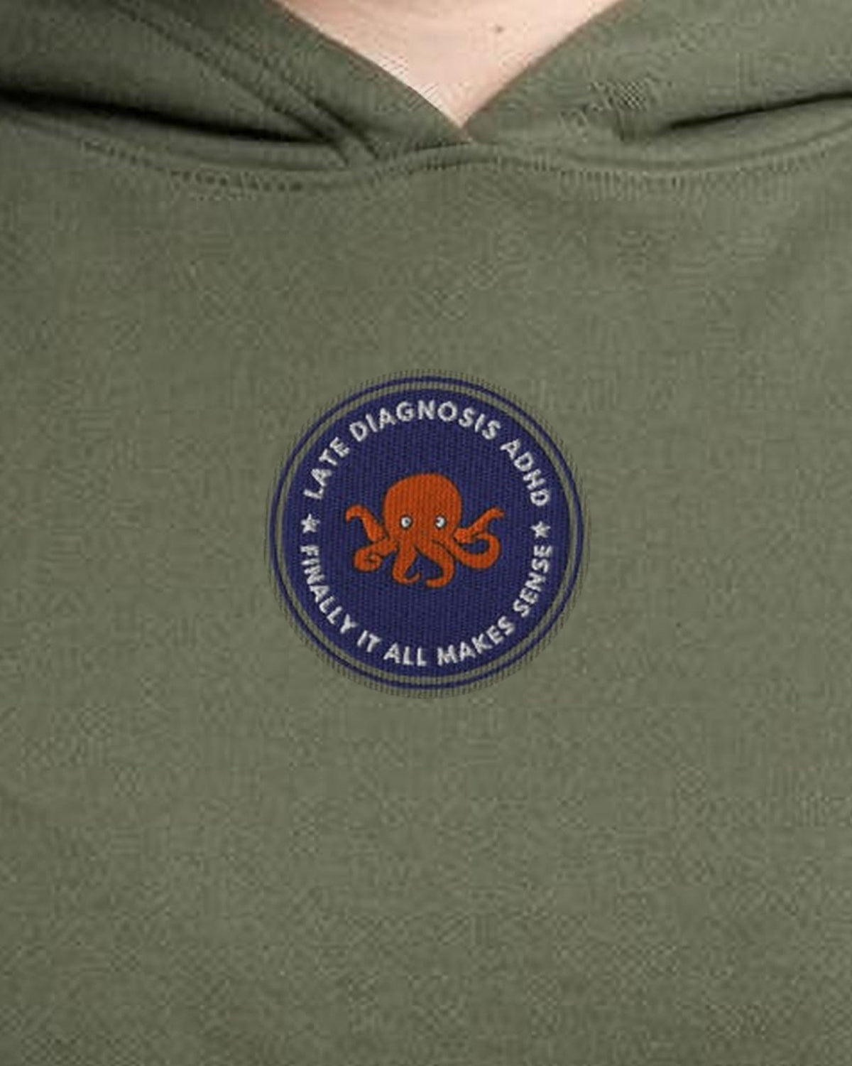 Finally ... ADHD embroidered crop hoodie in Military Green, worn, close-up of the chest design