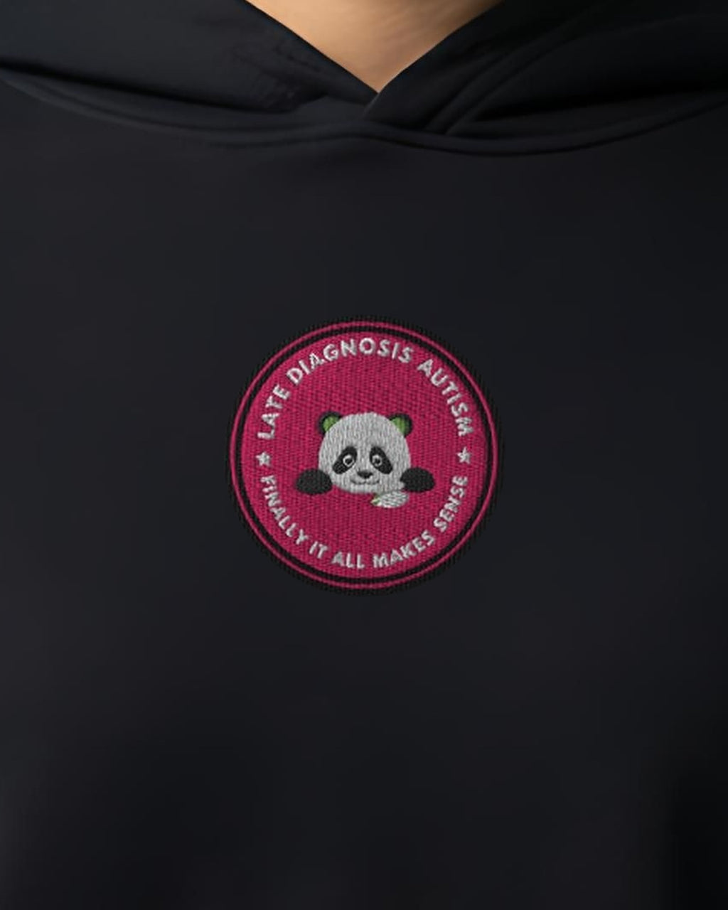 Finally ... Autism embroidered crop hoodie in Black, worn, close-up of the chest design