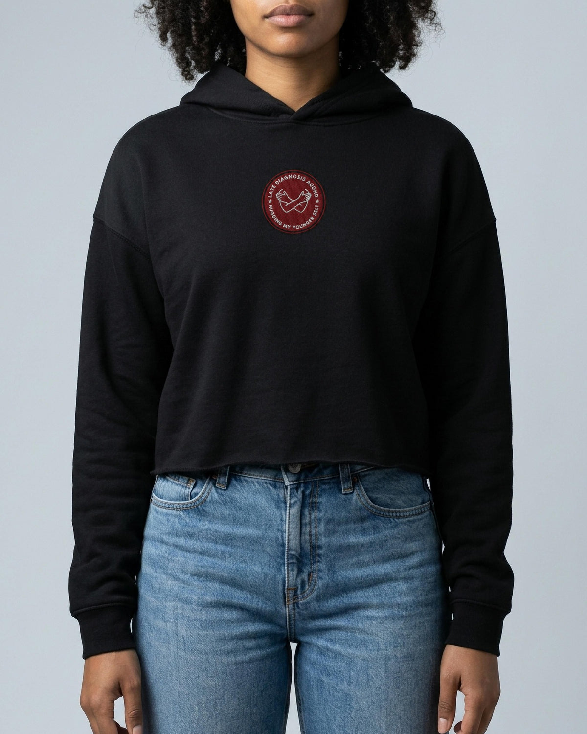 Hugging ... AuDHD embroidered crop hoodie in Black, worn, front view