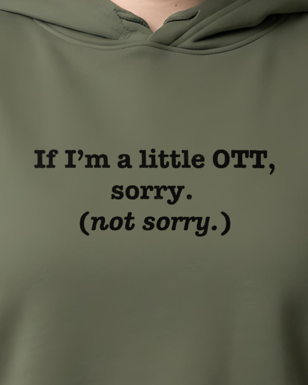 OTT? Sorry (Not Sorry) printed crop hoodie in Military Green, worn, close-up of the chest design