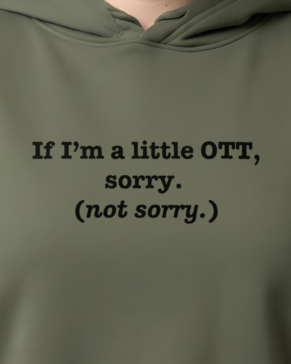 OTT? Sorry (Not Sorry) printed crop hoodie in Military Green, worn, close-up of the chest design