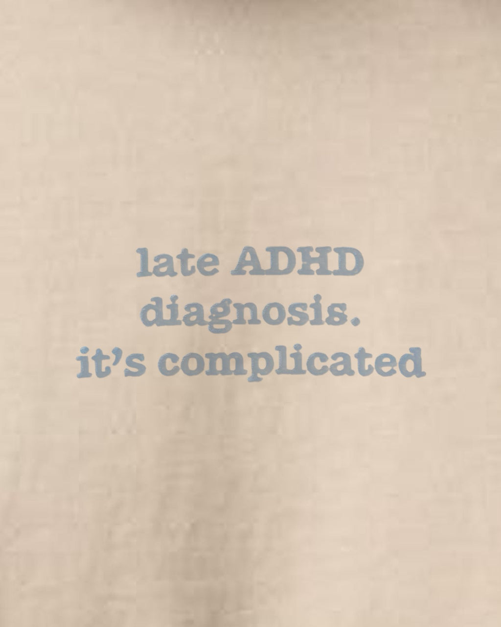 It's Complicated Phrase (ADHD) embroidered organic tee in Desert Dust, close-up of the embroidered slogan