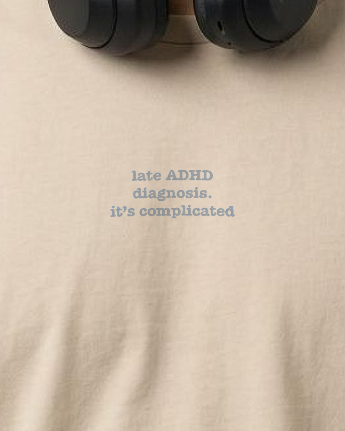 It's Complicated Phrase (ADHD) embroidered organic tee in Desert Dust, worn