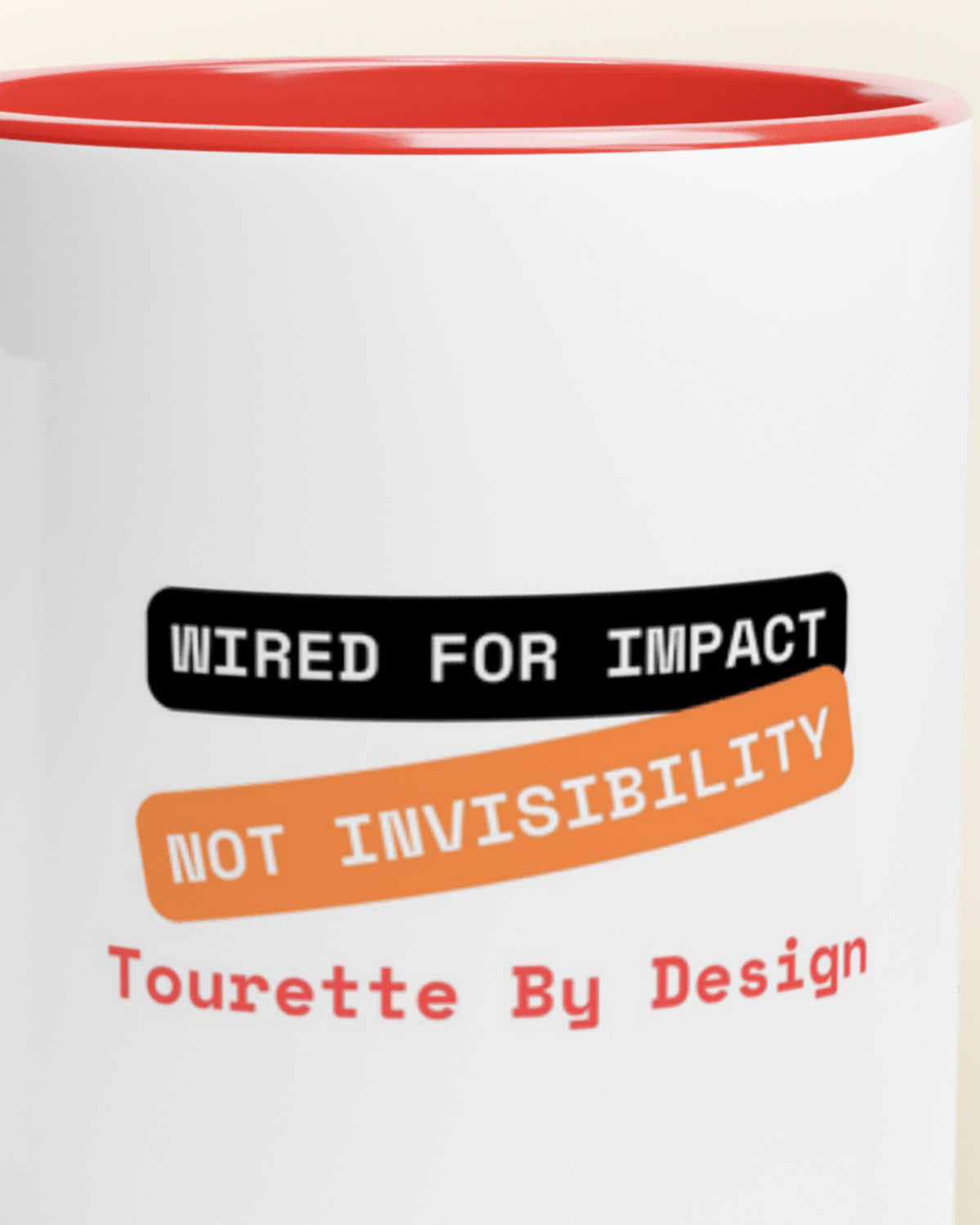 Close-up of the "By Design (Tourette)" wording
