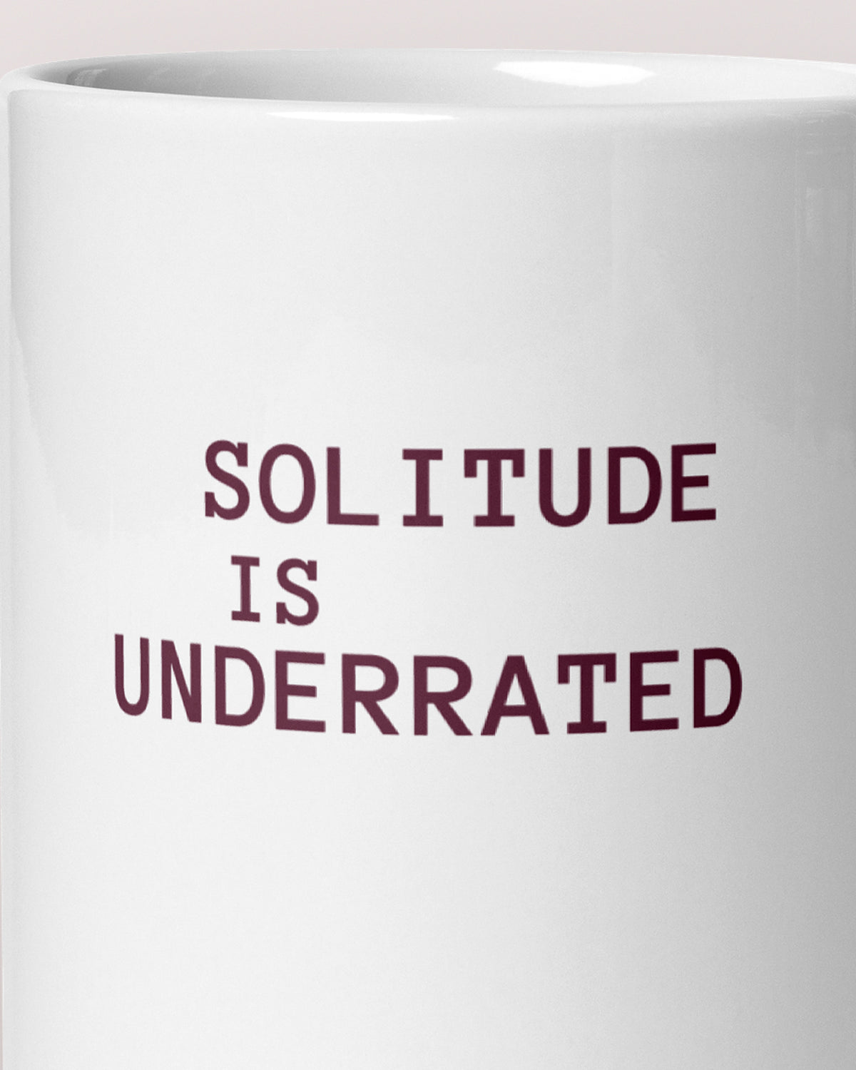 Close-up of the "Solitude Is Underrated" wording