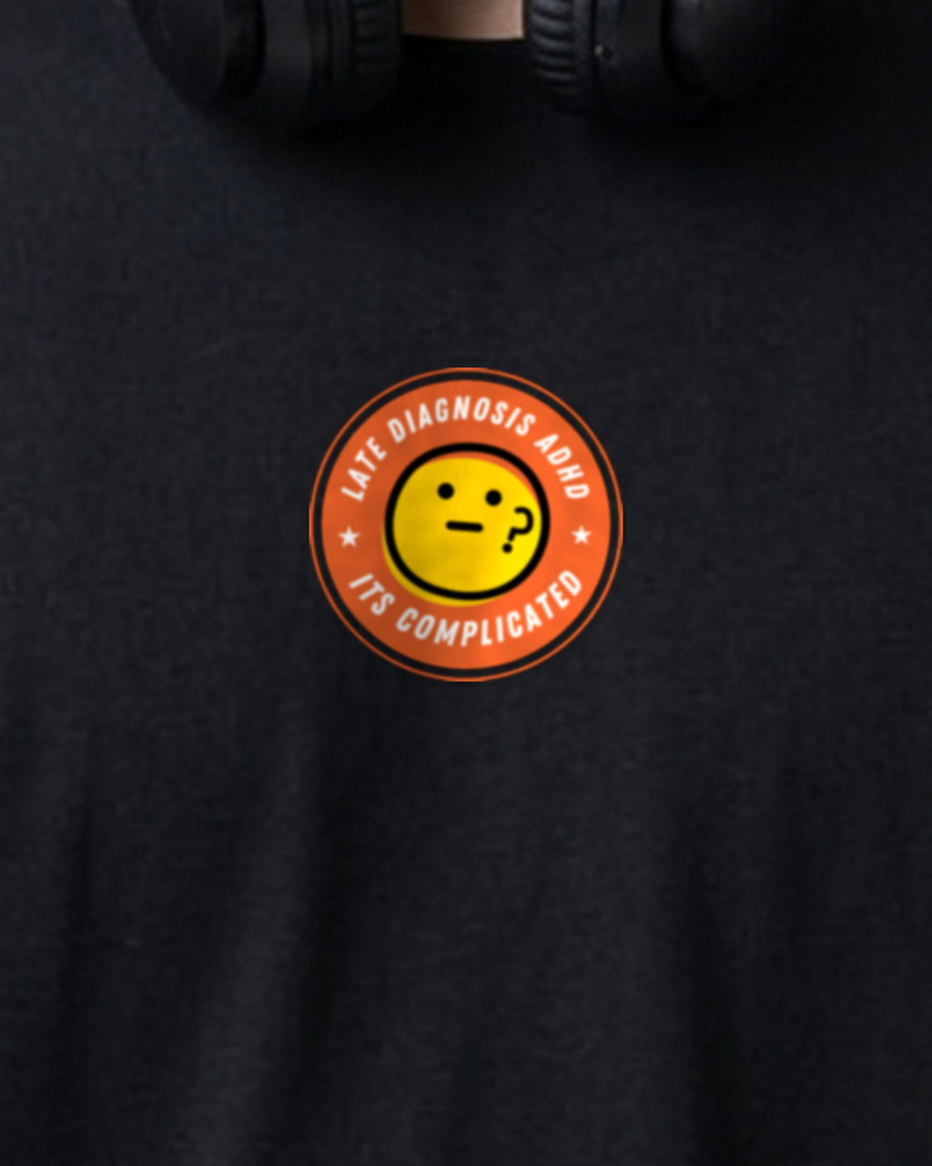 It's Complicated emoji (ADHD) organic embroidered badge tee in Black, worn, close-up of the embroidered badge