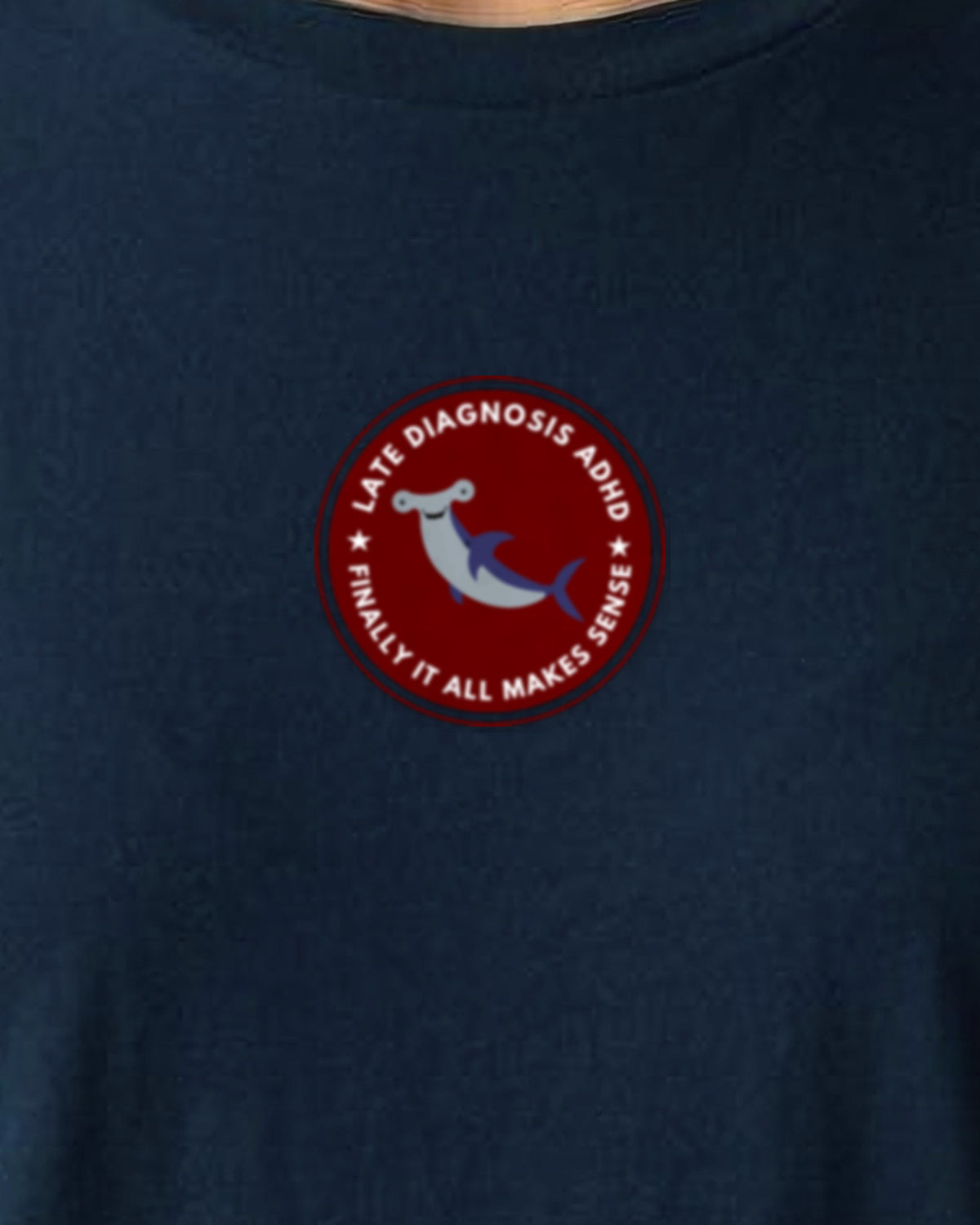 Finally (ADHD) organic embroidered badge tee in French Navy, worn, close-up of the embroidered badge