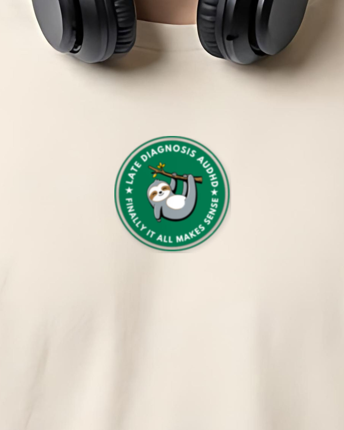 Finally (AuDHD) organic embroidered badge tee in Vintage White, worn, close-up of the embroidered badge