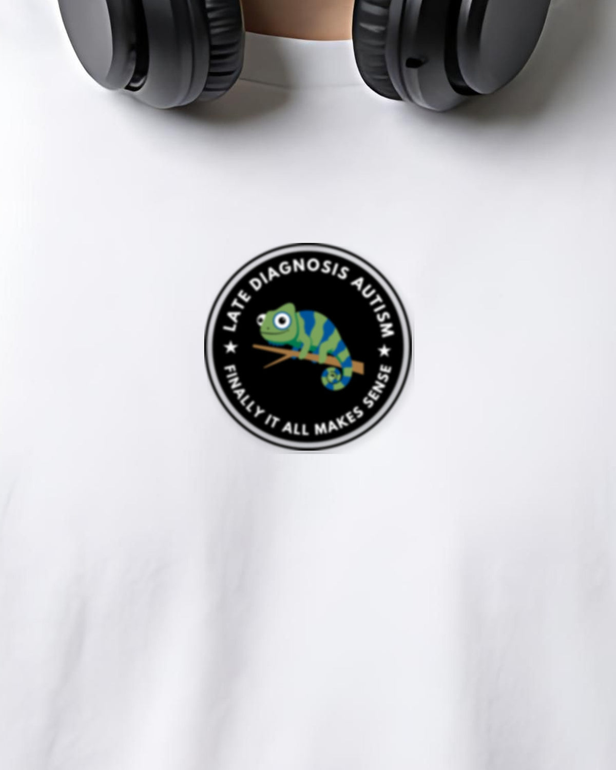 Finally (Autism) organic embroidered badge tee in White, worn, close-up of the embroidered badge