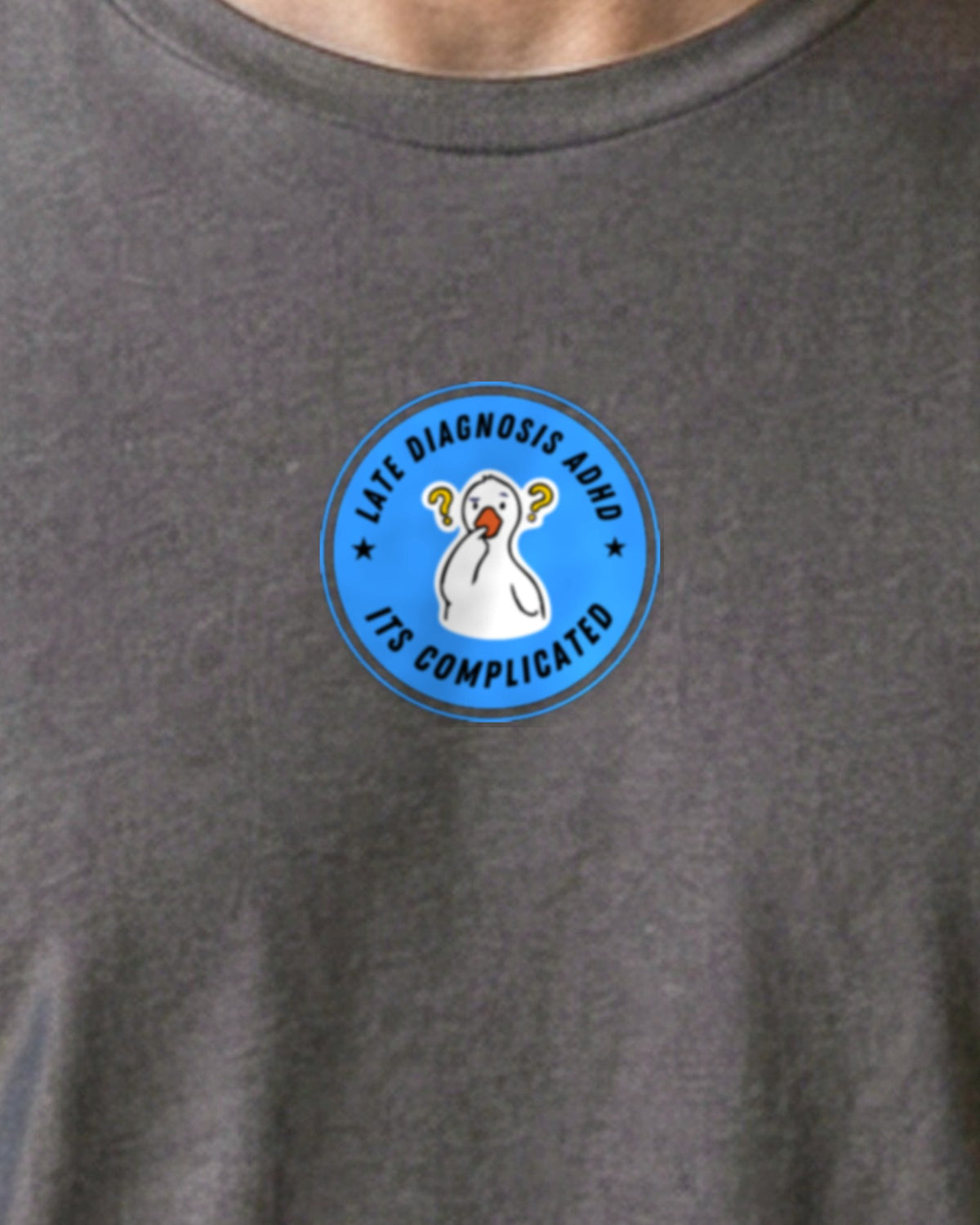 It's Complicated mouse (ADHD) organic embroidered badge tee in Anthracite, worn, close-up of the embroidered badge
