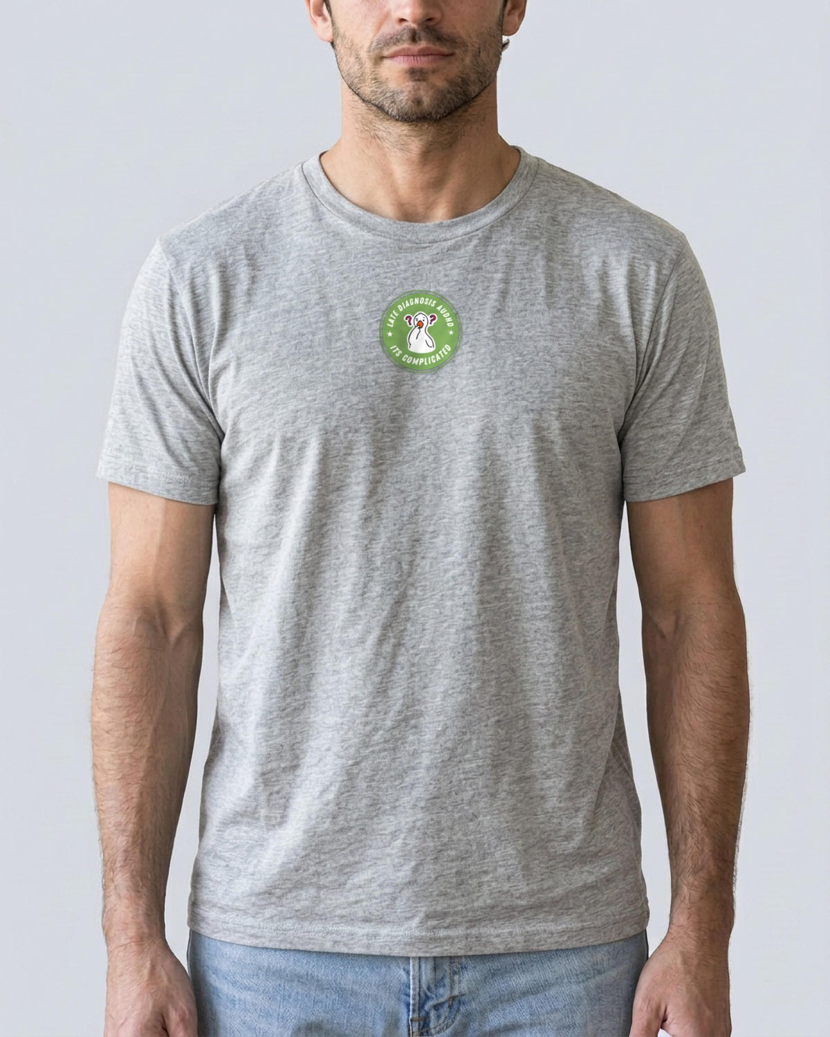 It's Complicated mouse (AuDHD) organic embroidered badge tee in Heather Grey, worn, full front view