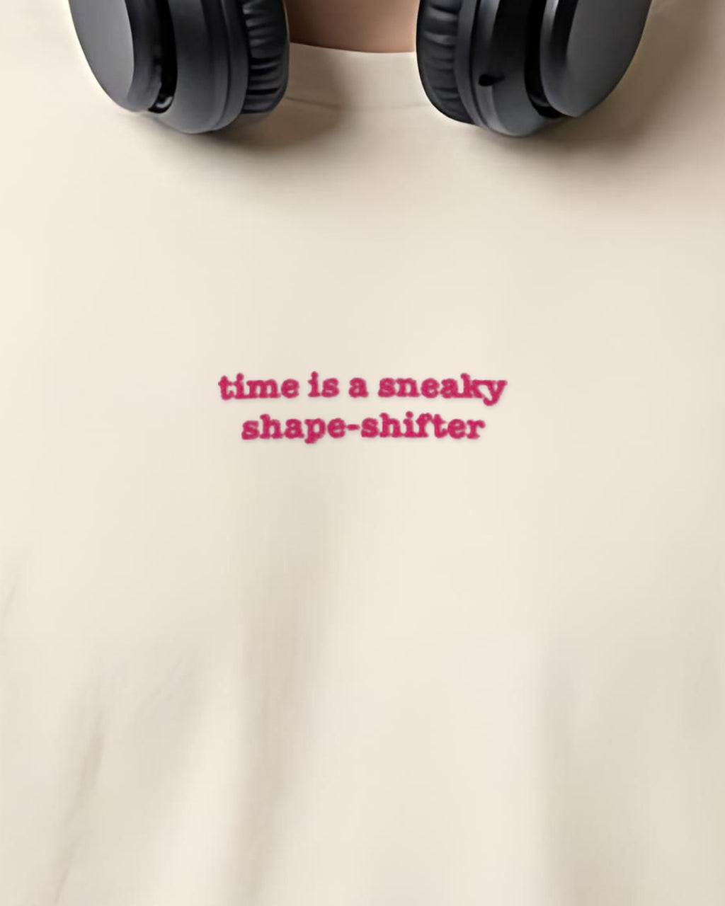 Time ... Sneaky Shape Shifter embroidered organic tee in Vintage White, worn, close-up of the chest embroidery