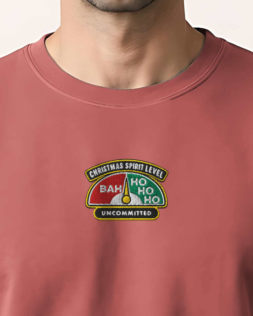 Christmas Spirit Level embroidered sweatshirt in Crimson, worn, close-up of the stitched gauge badge