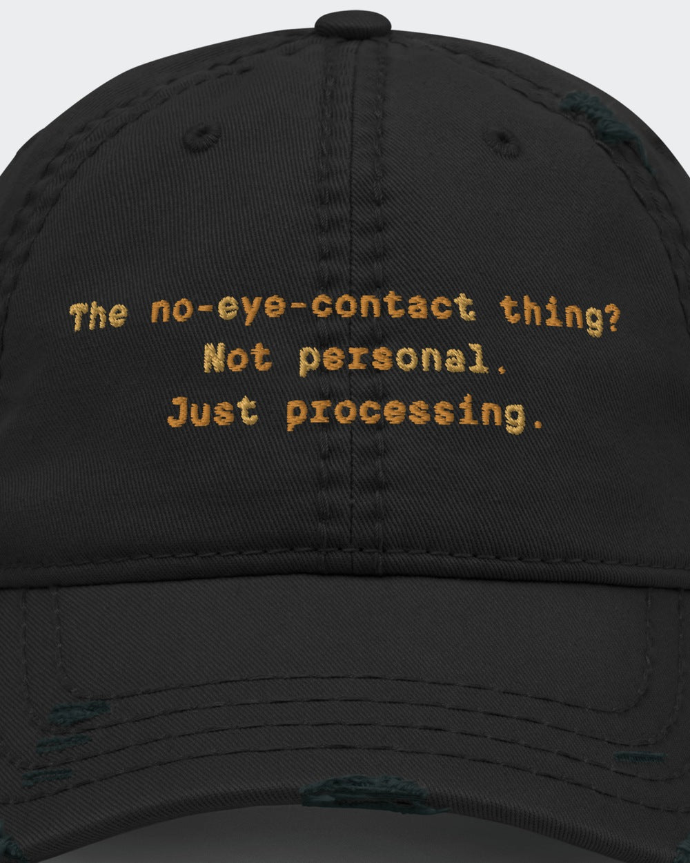 The No-Eye-Contact Thing? distressed dad hat in Black, close-up of the embroidered slogan