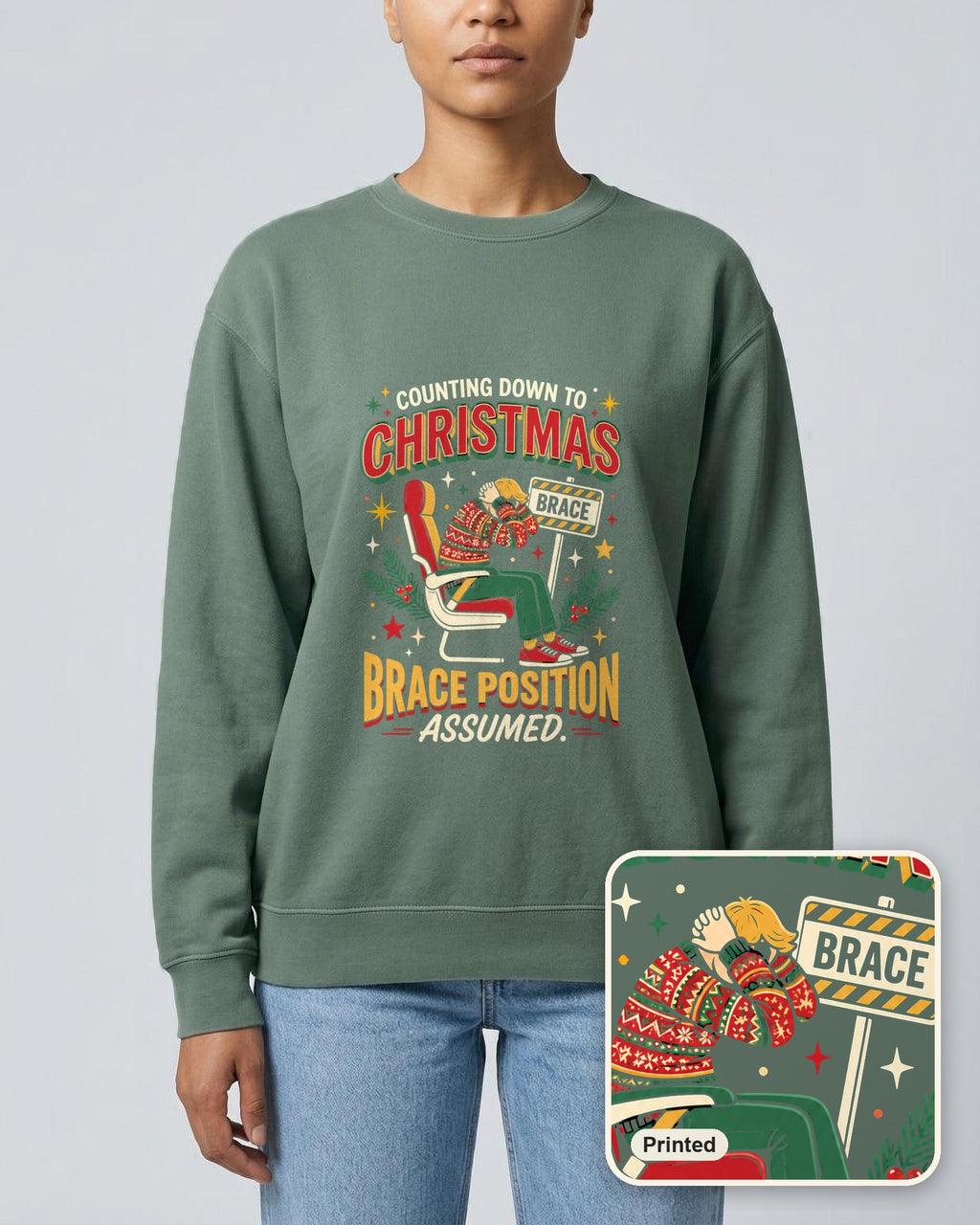 Christmas Countdown: Brace Position sweatshirt in Blue Spruce, worn, with a close-up showing the design is printed