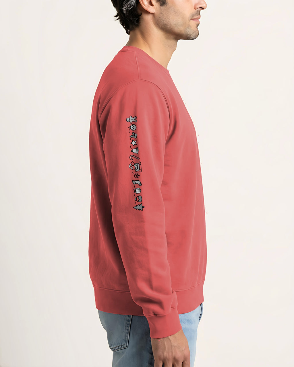 Understated Christmas sleeve sweatshirt in Watermelon, worn, side view with the print running down the right sleeve